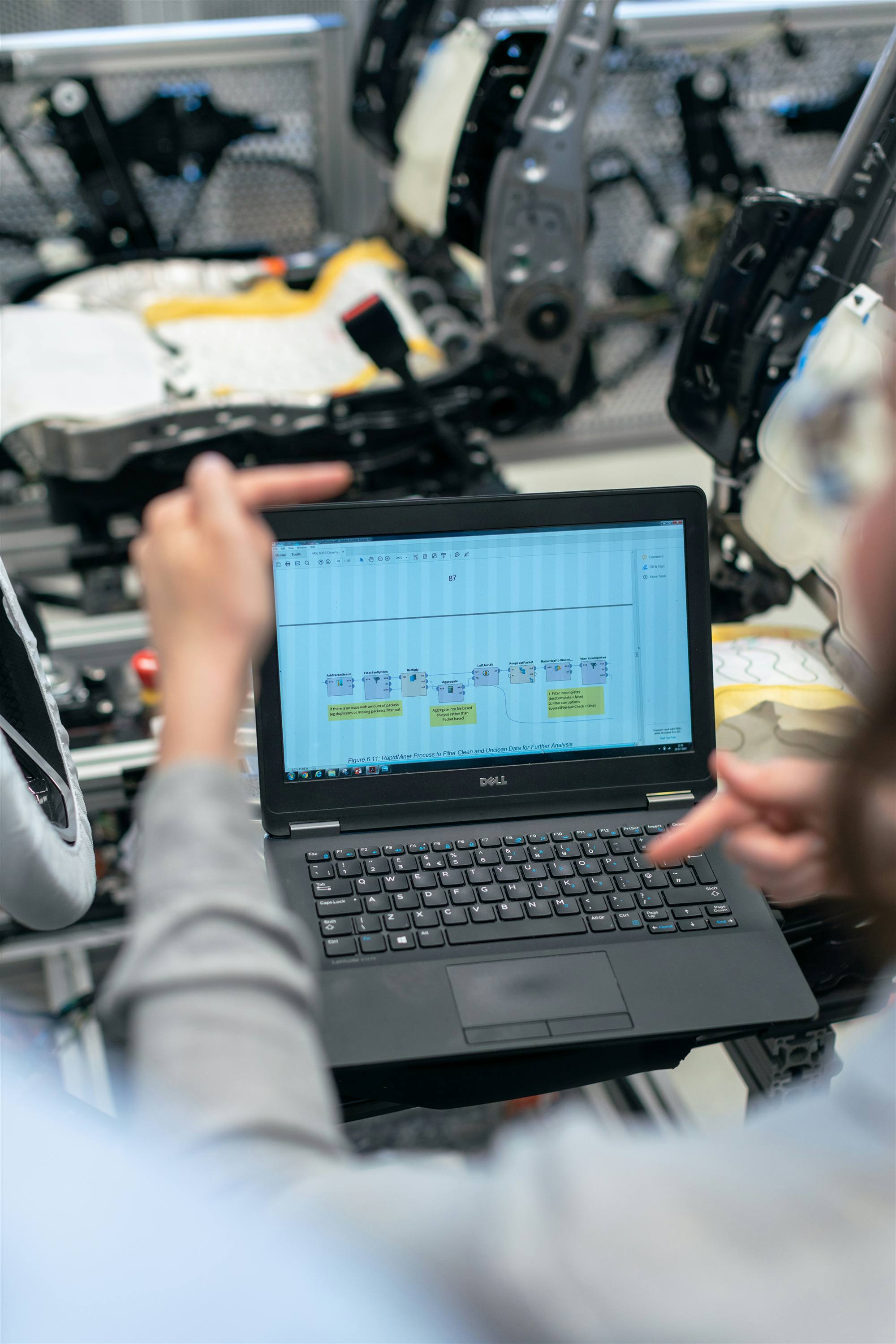 Engineer working in modeling software on a large monitor